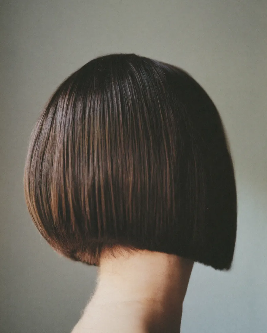 A sharp chin-length bob in dark brown, seen from behind.