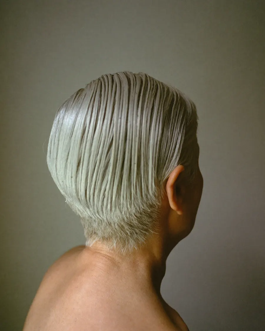 A silver pixie cut, grey left natural.